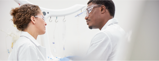 Cell therapy scientists in front of a Sefia cell processing system
