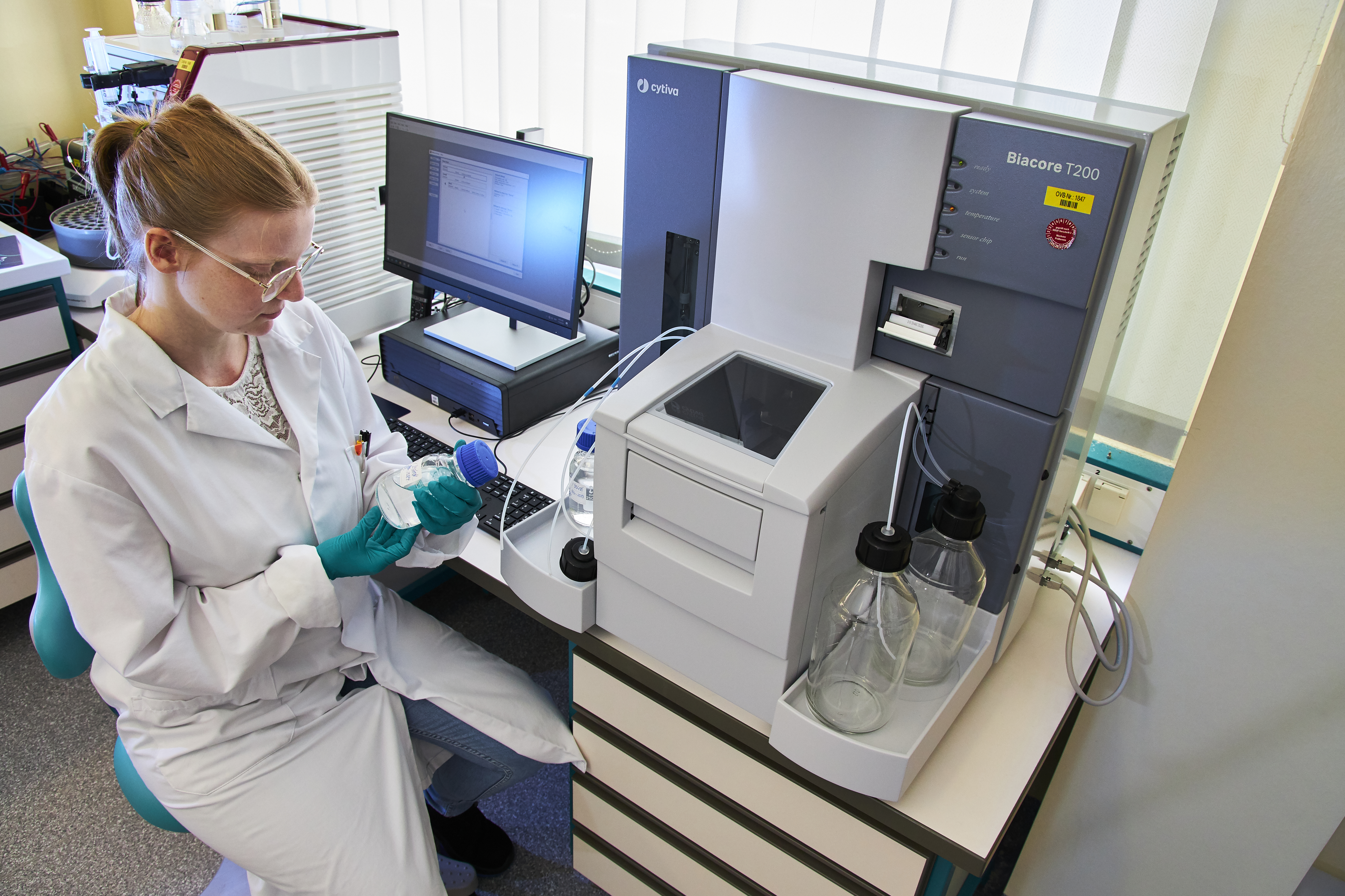 Scientist setting up a Biacore machine 2