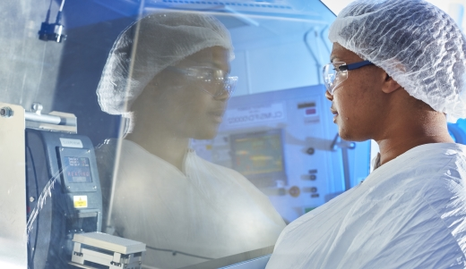 Scientist peering into instrument in Cardiff