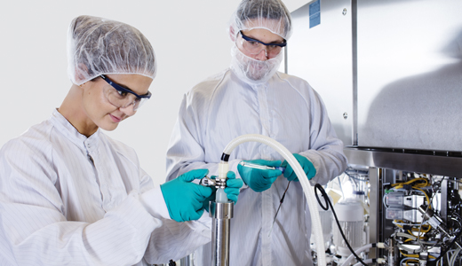 Operators in a cleanroom with AxiChrom anf BioProcess equipment.