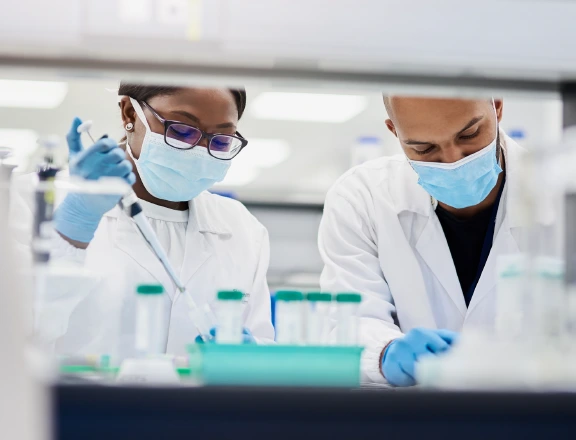 Scientists optimizing formulations in a lab